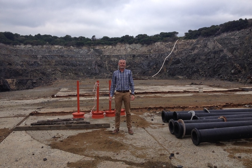King Island Scheelite project manager Alvin Johns standing in a big open-cut mine pit in Grassy on the island's south-east.