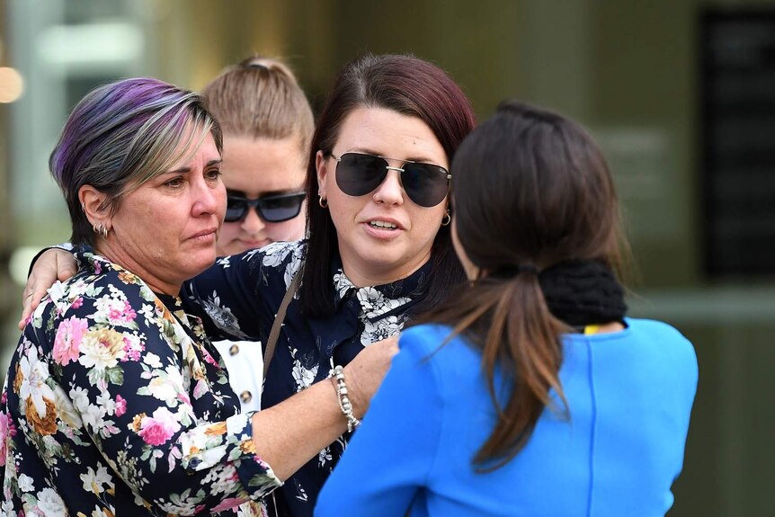 Josie Cleeland (centre), the daughter of Barry Willis who was killed while working for Brisbane Auto Recycling, outside court.