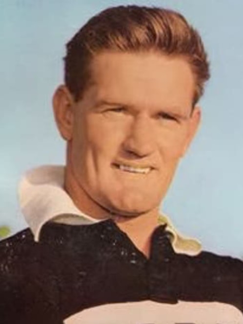 A historical headshot of a man looking off camera and smiling slightly