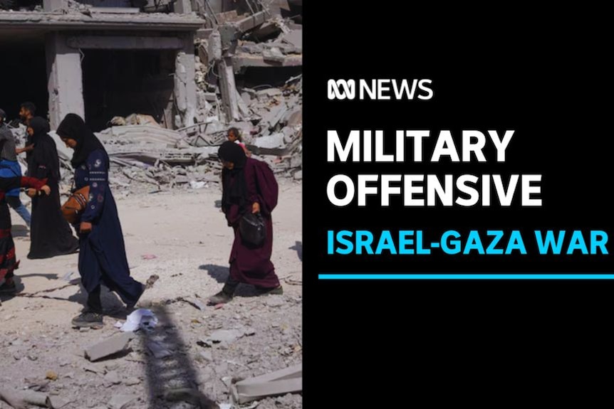 Military Offensive, Israel-Gaza War: Women walk through a bombed-out urban landscape.