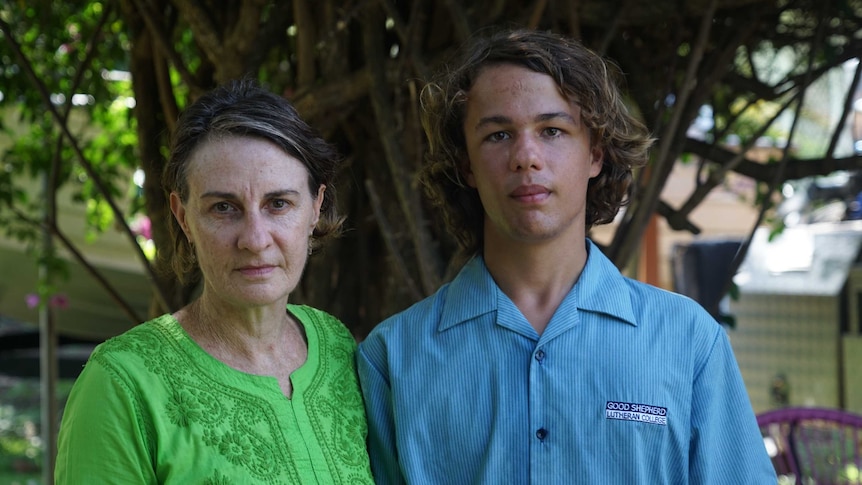 Tracey Farrar is wearing a green shirt and looks serious. Her son Bradley wears a Good Shepherd Lutheran College uniform.