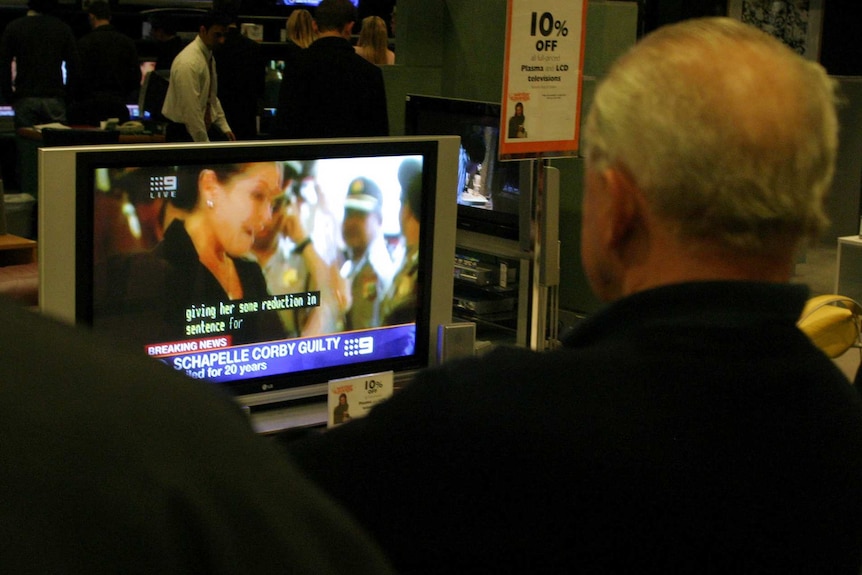 People watch a channel nine broadcast of the Schapelle Corby verdict on television in a Sydney department store