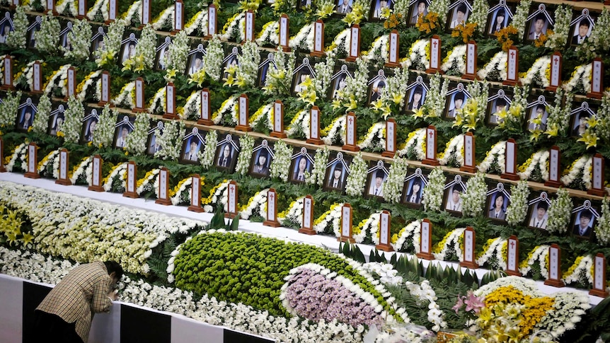 A woman mourns at a temporary group memorial altar in Ansan for the victims of the sunken passenger ship Sewol.