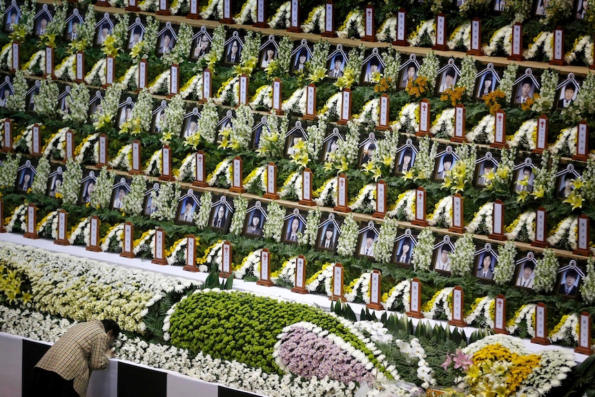 A woman mourns at a temporary group memorial altar in Ansan for the victims of the sunken passenger ship Sewol.