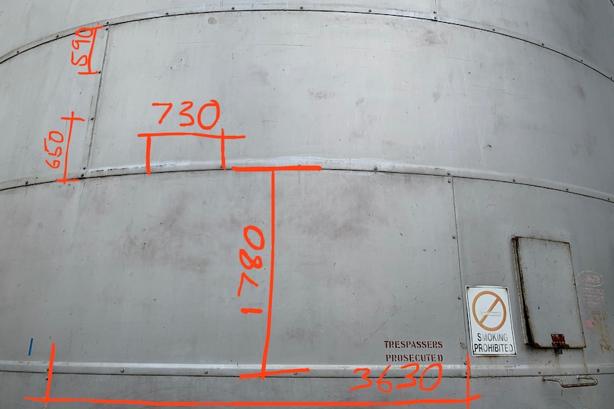 Metal silo with measurements drawn on digitally