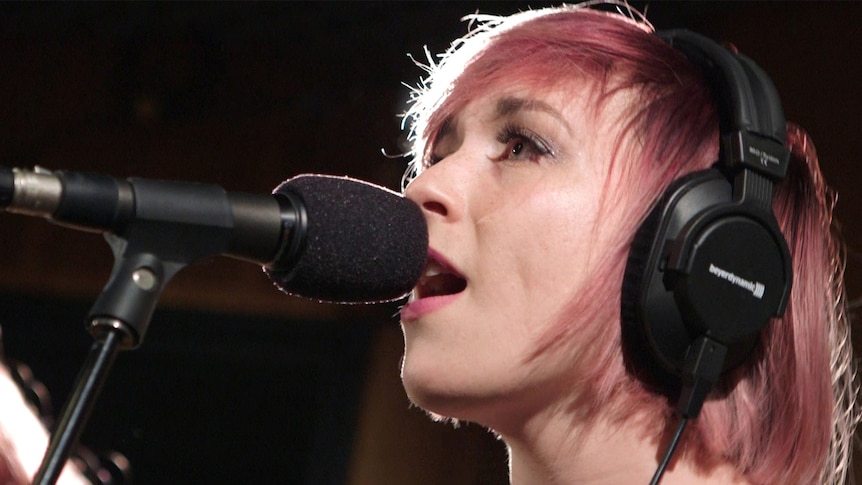 A photo of Alpine doing a live performance of 'Cigarettes Will Kill You' in the triple j studios