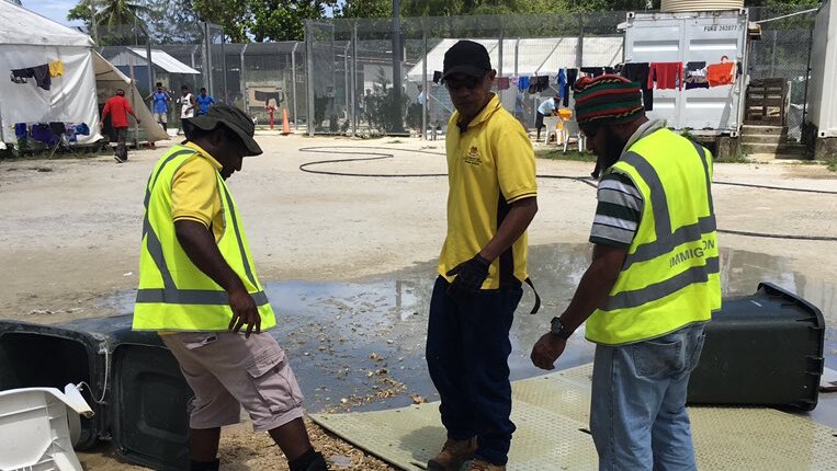 Immigration officials in the Manus Island detention centre burying drinking water wells.