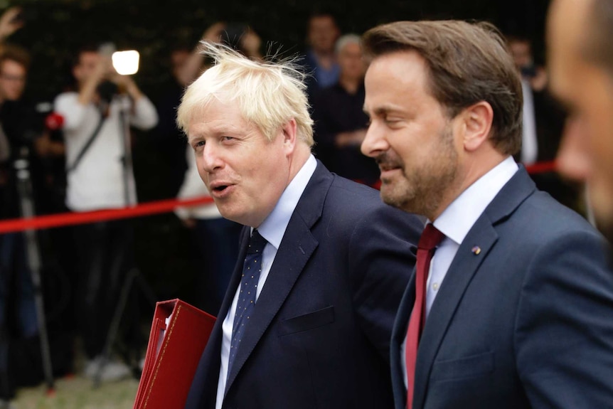 Boris Johnson and Xavier Bettel walk in the garden after a meeting at Mr Bettel's office in Luxembourg.