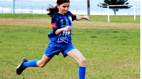 Girl kicks a ball