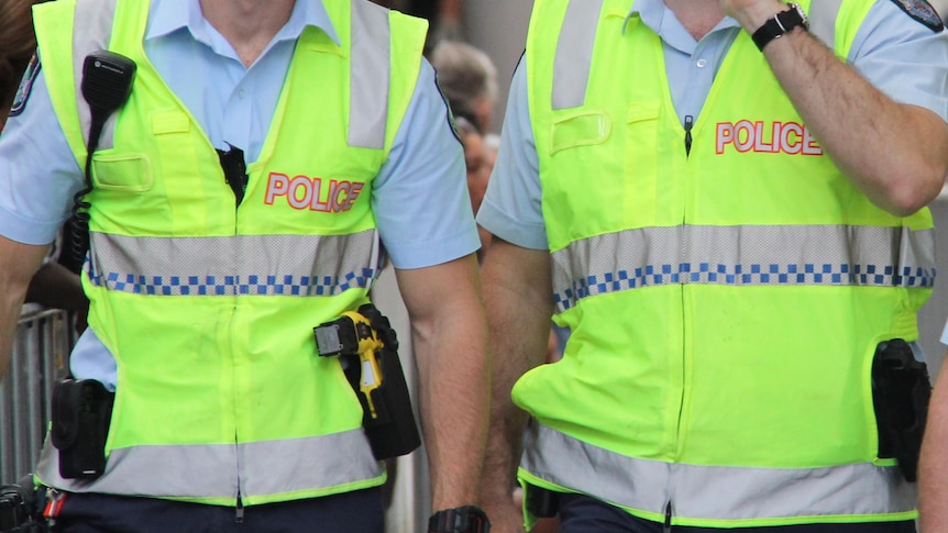 Queensland Police walk through the Queen Street Mall