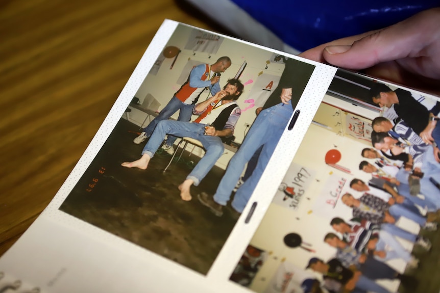 A photo of two men smiling in a photo book