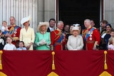 Members of the British royal family gather on a balcony at Buckingham Palace.