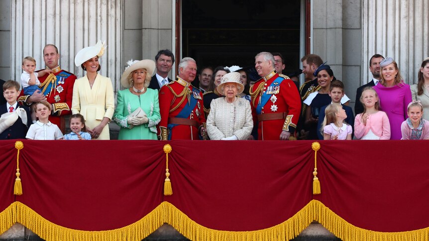 The Queen and several other members of the royal family squeeze onto a balcony together in their finery