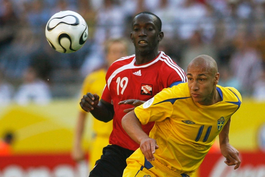 Sweden's Henrik Larsson (R) and Trinidad and Tobago's Dwight Yorke in action at the 2006 World Cup.