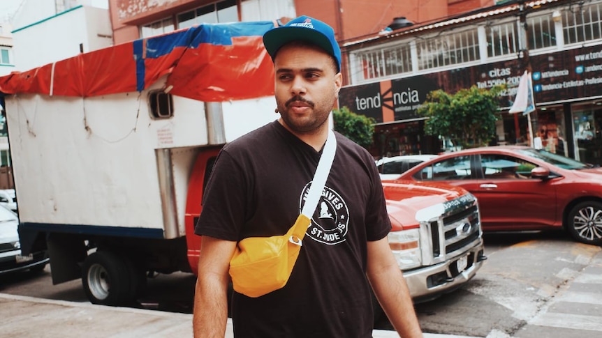 Image of Joji Malani; photographed on the street in Mexico, in front of truck