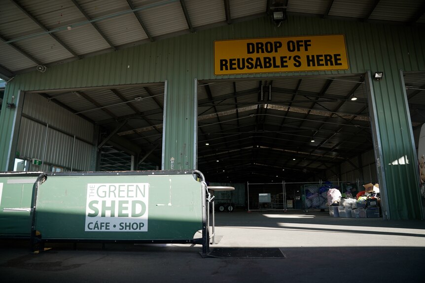 a recyling depot with a sign that says drop off reusables here