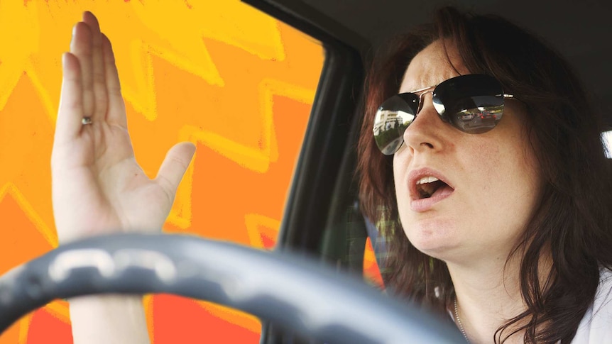 A woman wearing sunglasses while driving raises her hand with a frustrated look on her face.