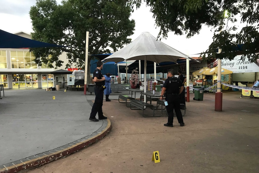 Police standing at a crime scene at a shopping centre