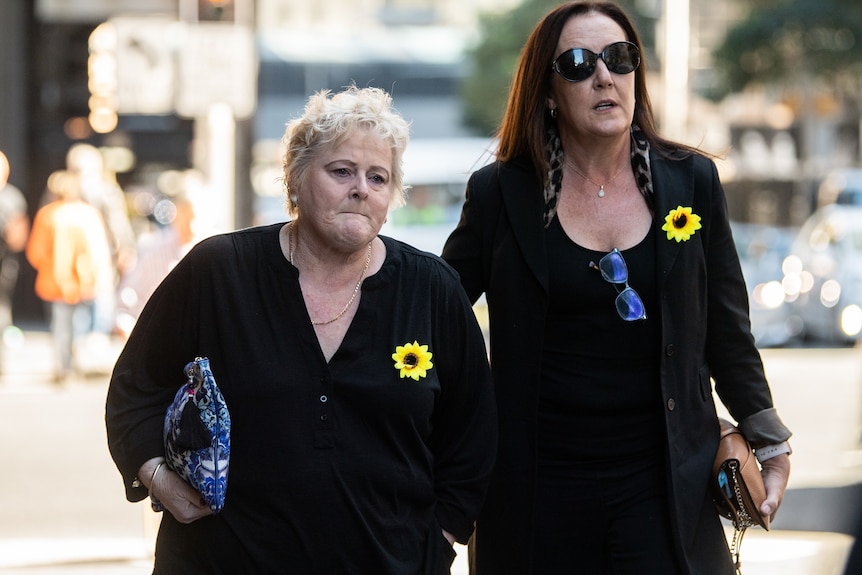 Two women, including Joanne Dunn, wearing black look sad