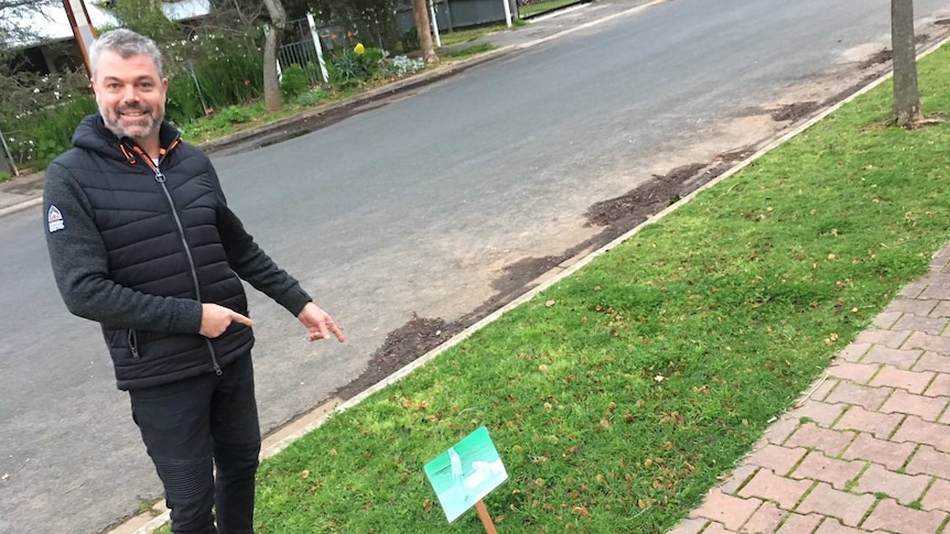 Steve Tamblyn stands on the grass outside his Lower Mitcham home.