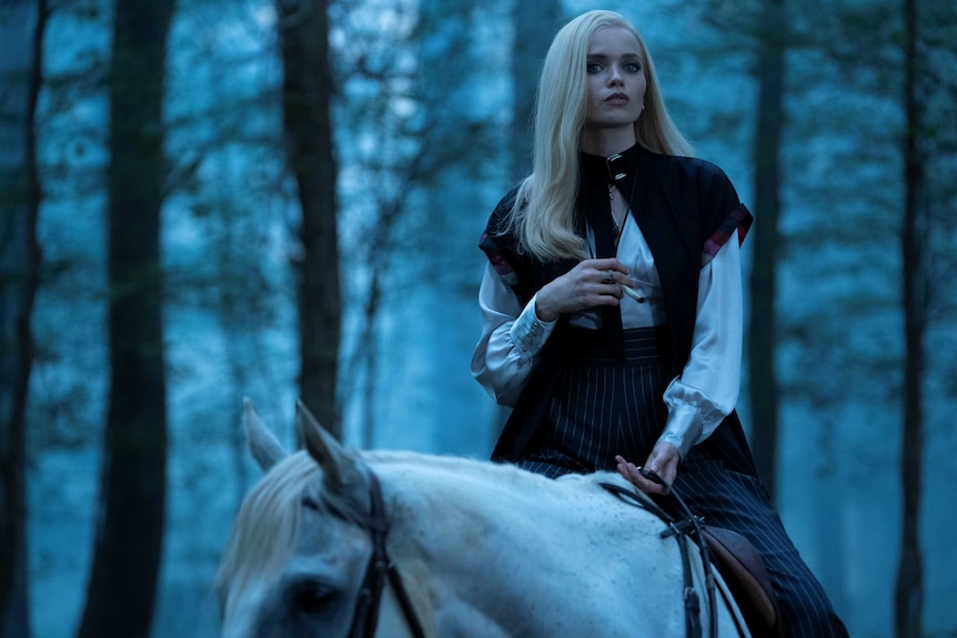 Actor Abbey Lee on a horse in a forest in TV show Lovecraft Country