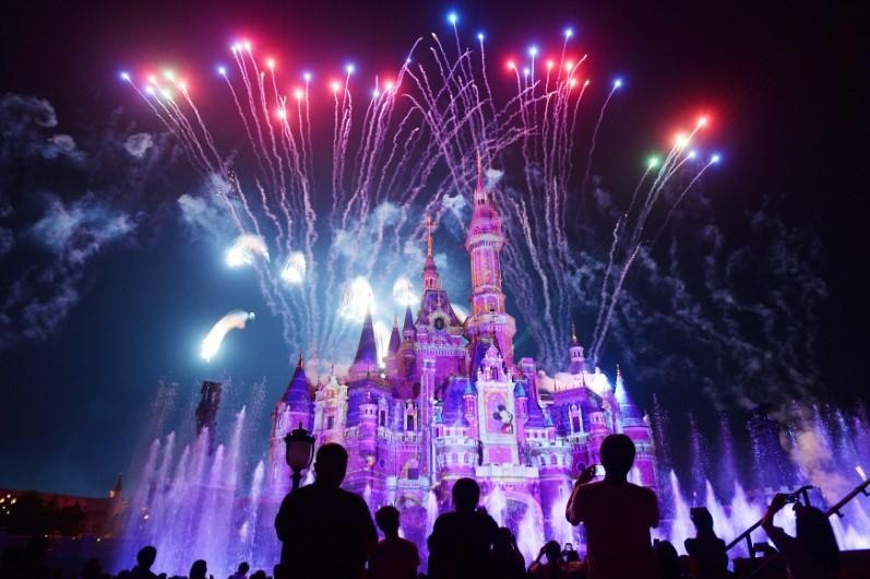 Fireworks explode over Shanghai Disney Resort at night time.