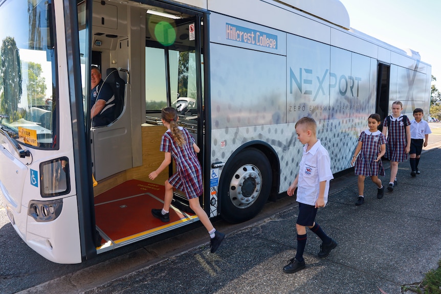 children walking on to a bus