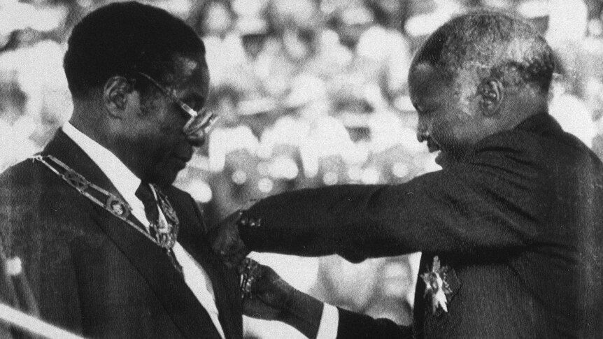 Robert Mugabe is sworn in as Zimbabwe's first executive president by former president Canaan Banana.