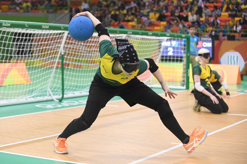 A goalball player gets ready to throw the ball.