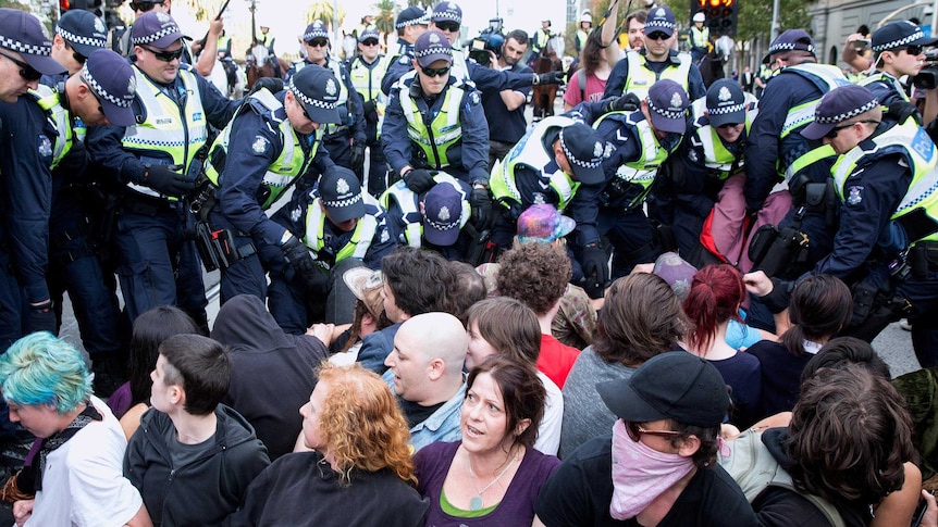 Police remove protesters in Melbourne, during protests against the Abbott Government's budget cuts.