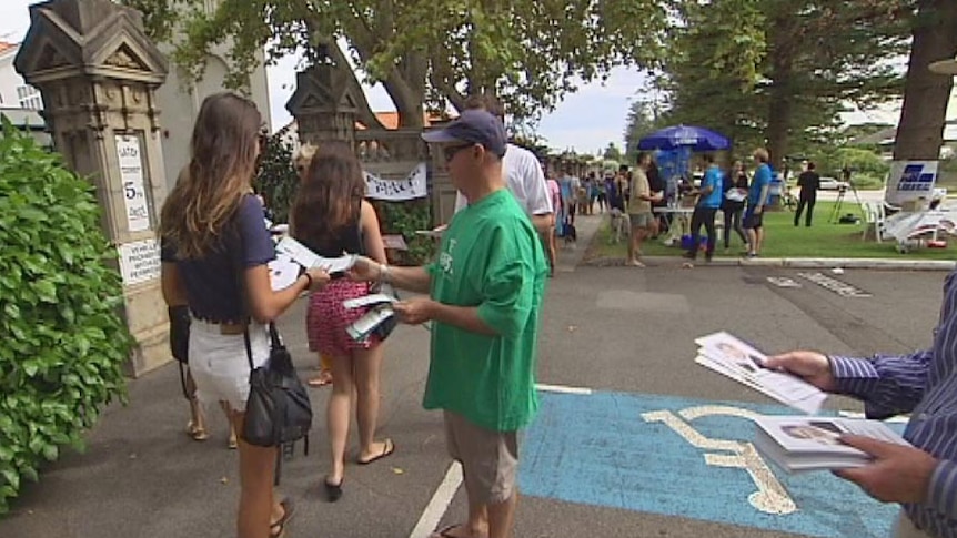 Voters at Cottesloe being handed leaflets