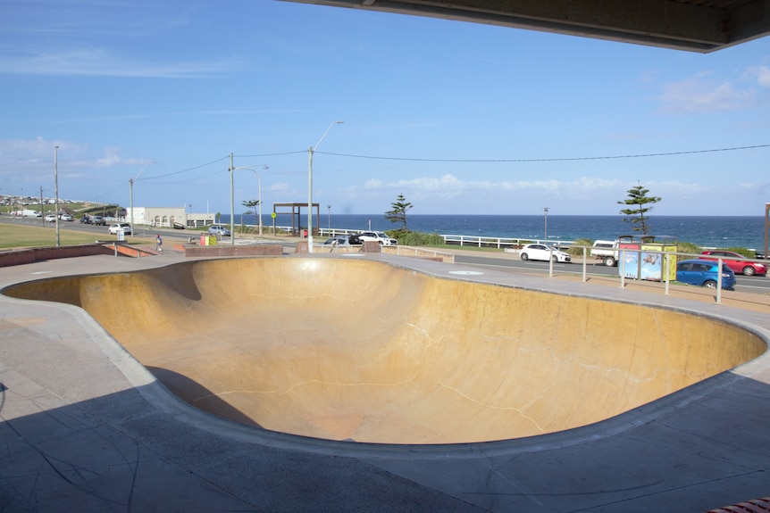 A large skate bowl with the ocean in the background