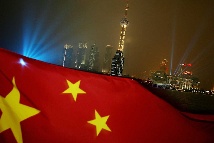 The Chinese flag flies with the Pudong skyline in the background