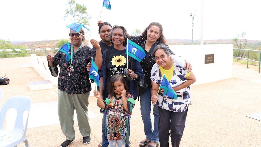 A group holds Torres Strait Islander flags