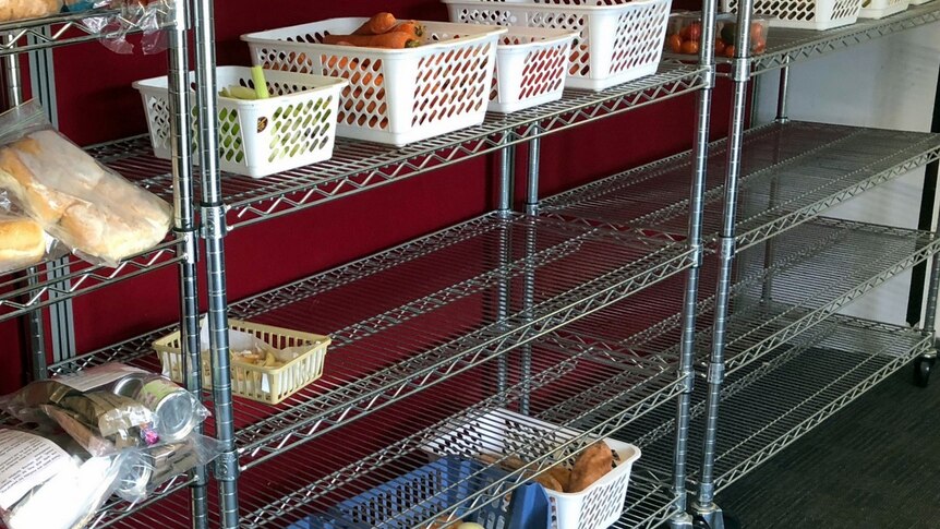 Bare shelves at charity food donation base.