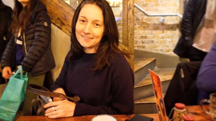 Melany Markham smiles in a generic facebook photo in a cafe