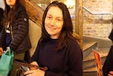 Melany Markham smiles in a generic facebook photo in a cafe