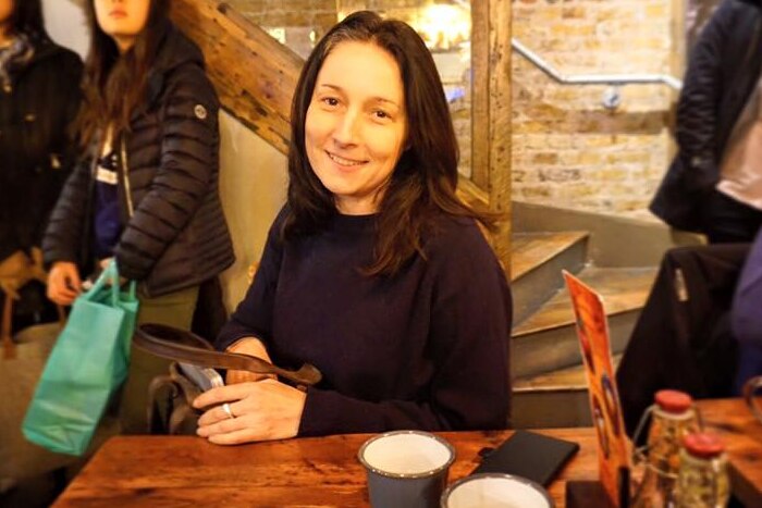 Melany Markham smiles in a generic facebook photo in a cafe