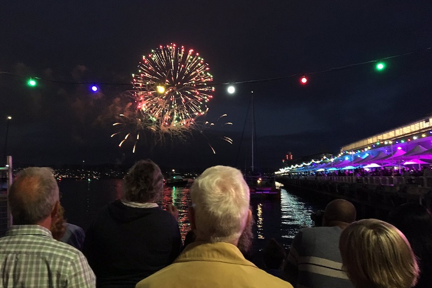 People watch fire works display.