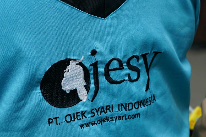 The back of an Ojesy driver's jacket worn by a female driver in Indonesia.