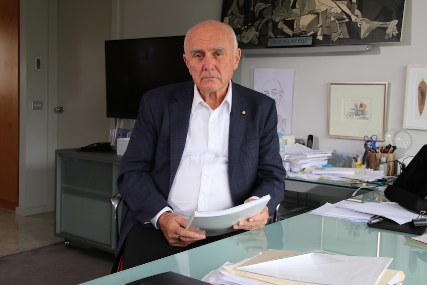 A man in an office with documents 