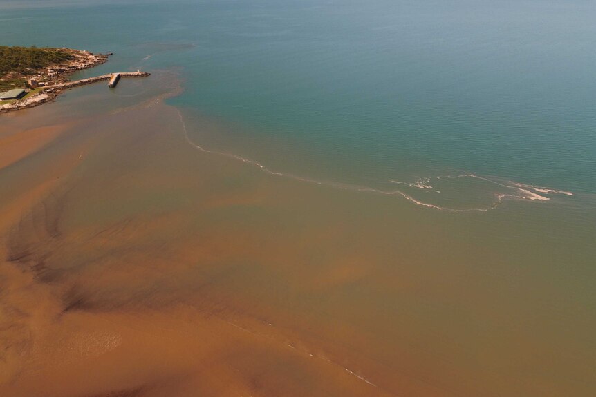 A flood plume washes sediment into the sea near Townsville