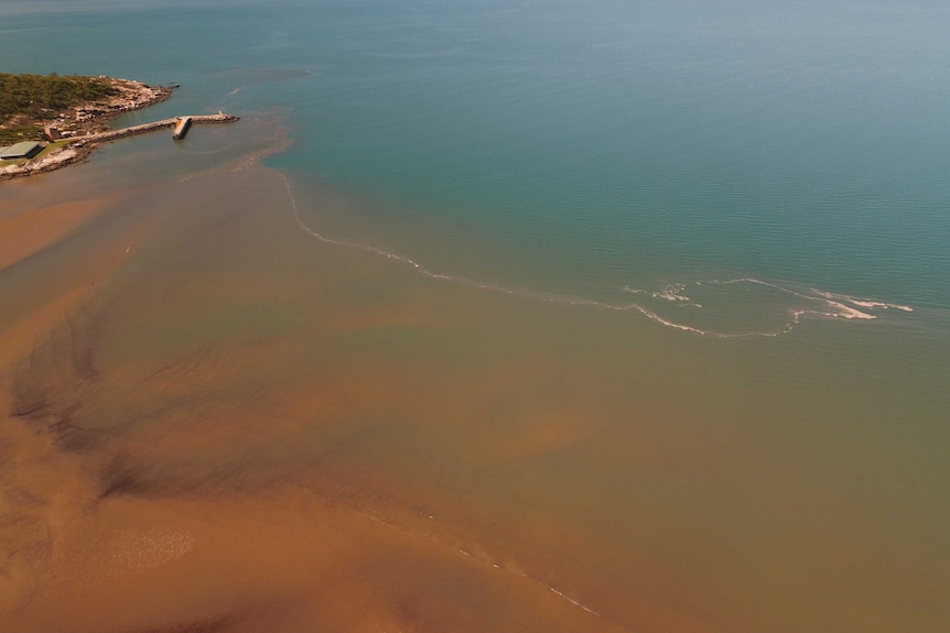 A flood plume washes sediment into the sea near Townsville