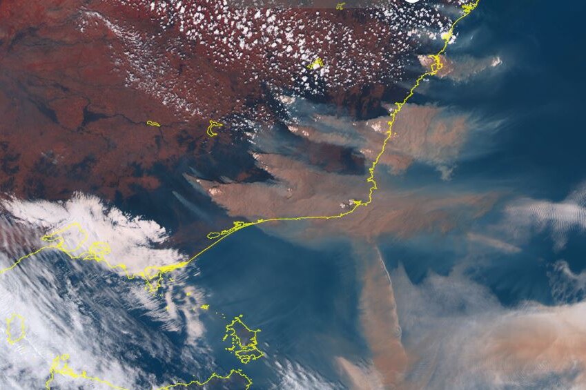 A satellite image shows south-eastern Australia through clouds and copious amounts of brown bushfire smoke.