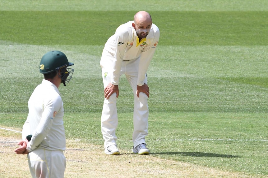 Australia bowler Nathan Lyon puts his hands on his knees and looks exhausted during a Test match at the MCG.