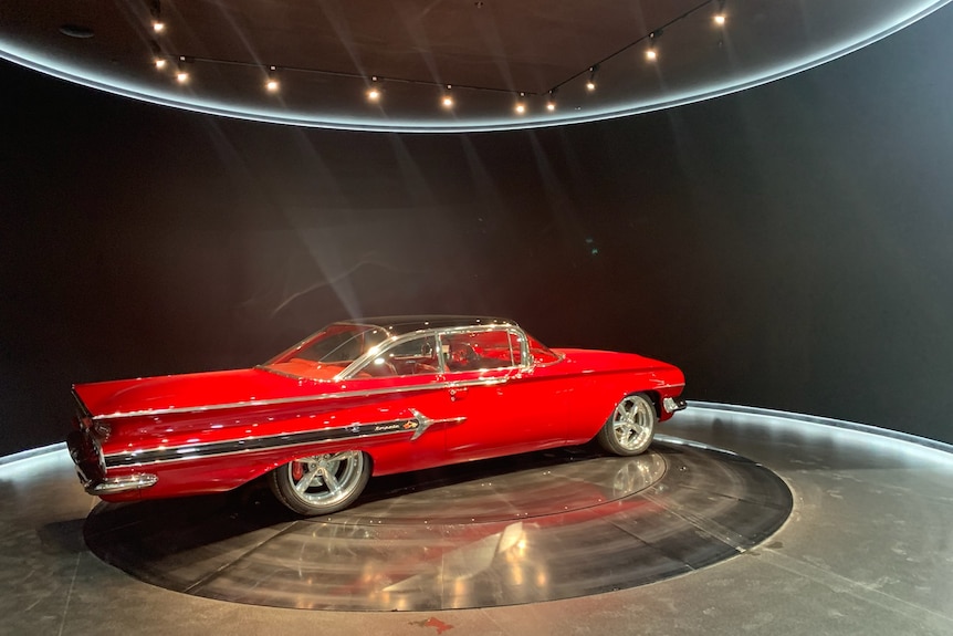 A vintage car on display in a museum.