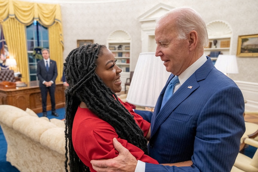 Joe Biden hugs a woman with long dark locks