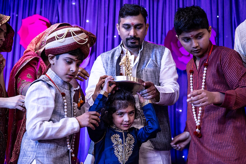 A young Jain wears a religious ornament, based on a dream by Lord Mahavira's mother.