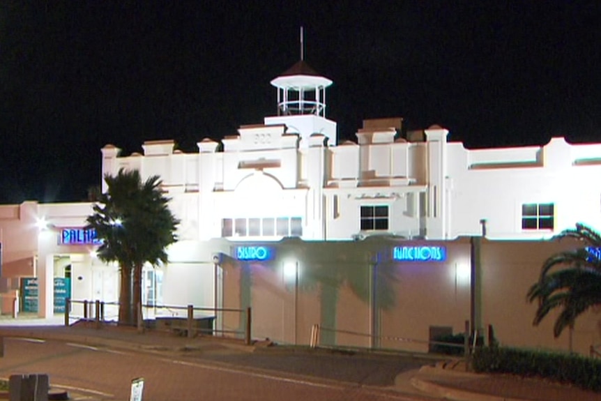 A white pub at night