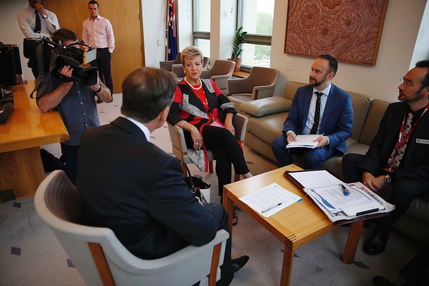 Mayor of Katherine Fay Miller's face is impassive as she faces Health Minister Greg Hunt in a meeting